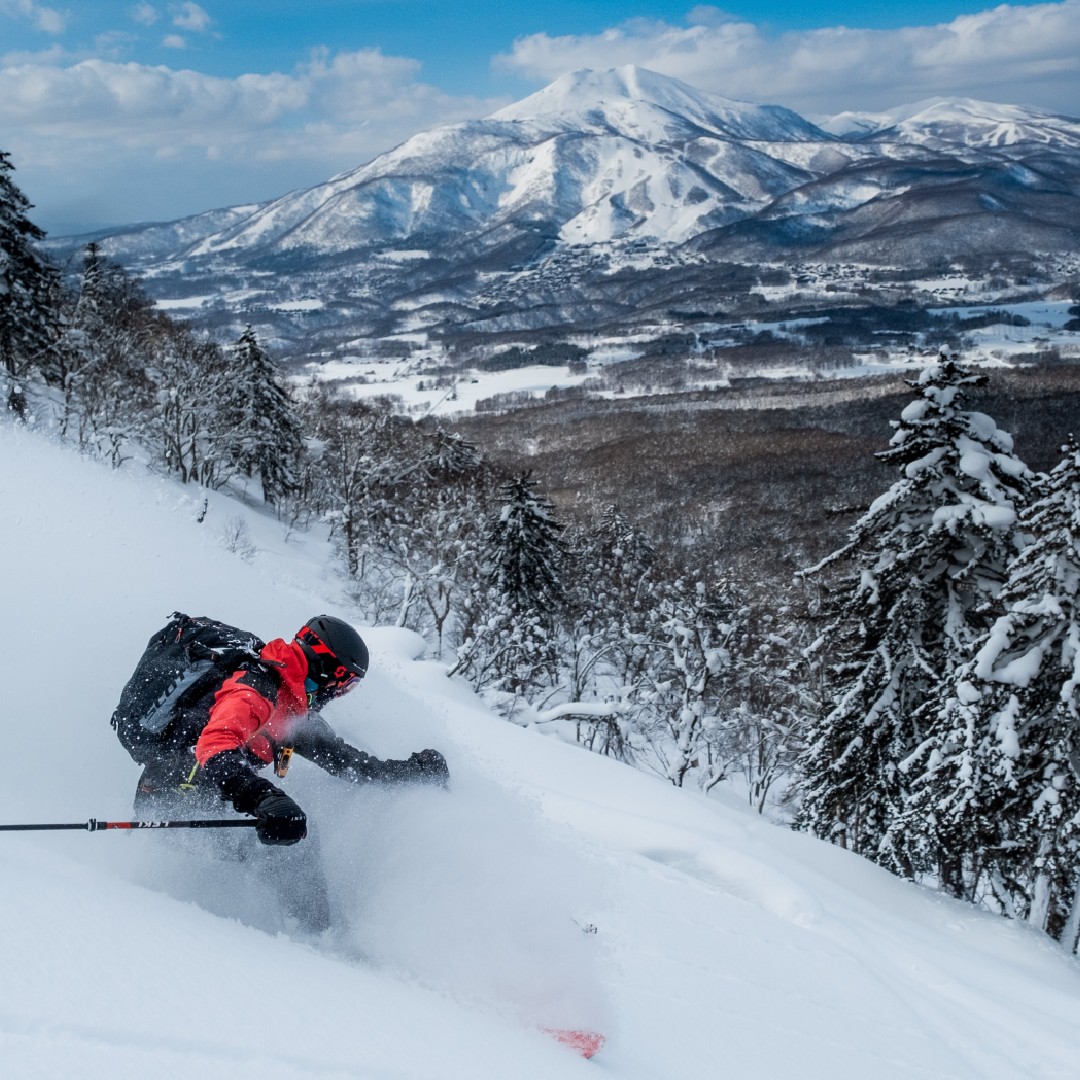 Skiing powder in Niseko with Mt. Yotei in the background