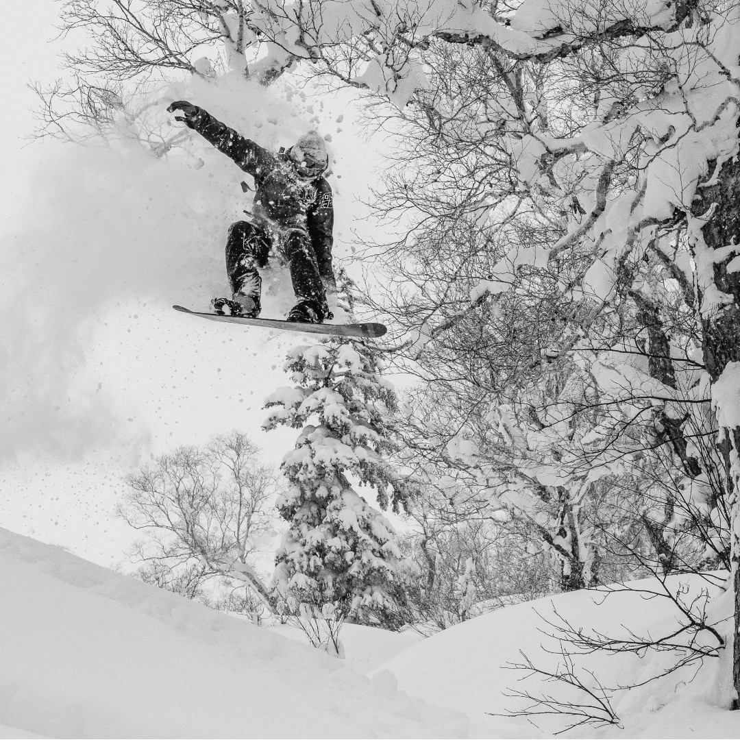 Snowboarder jumping powder pillows in Sapporo Kokusai