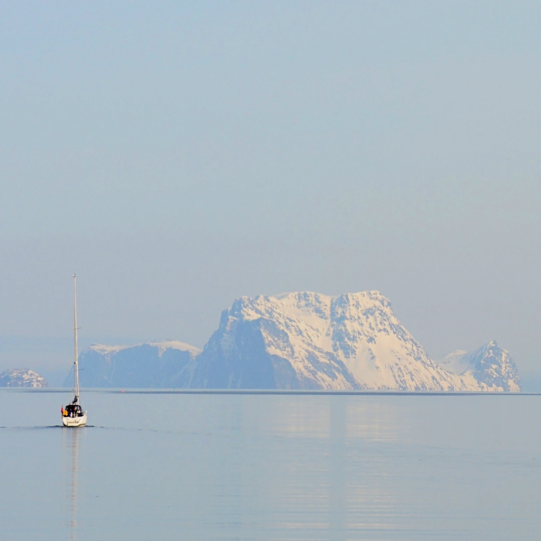 Boat sailing towards secluded island in the Arctic